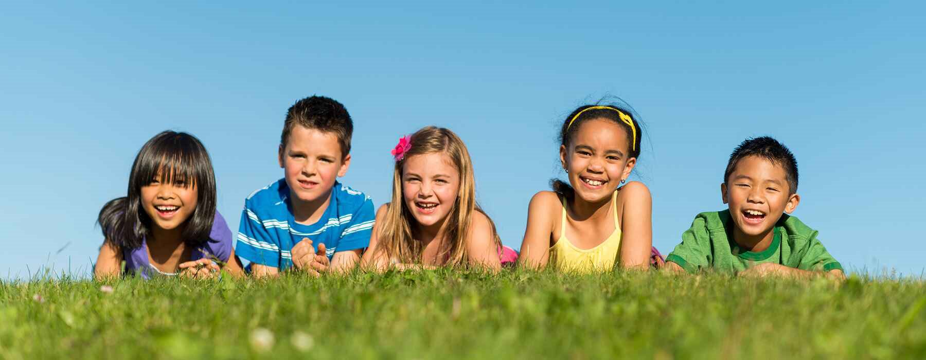 Kids enjoying the grass—healthy smiles start young in Closter, NJ
